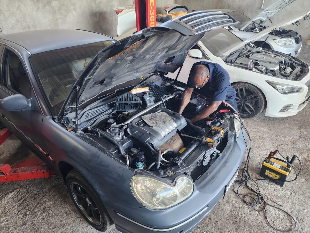 Mechanic working on a vehicle at Lectro's Auto Repair